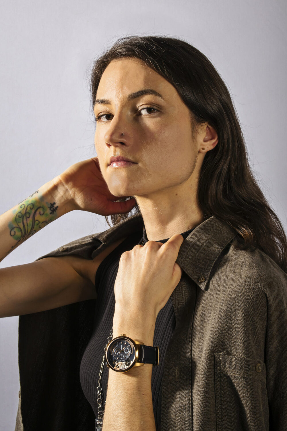 Studio portrait of woman wearing fossil watch